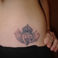 Stomach tattoo, heart with crown in hands