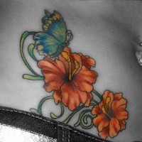 Stomach tattoo, butterfly flying above bright, orange flowers