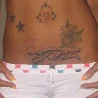 Stomach tattoo, designed inscription, flower, stars