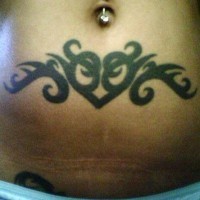 Stomach tattoo, black heart, decorated with curls