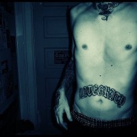 Stomach tattoo, cool styled inscription above the navel