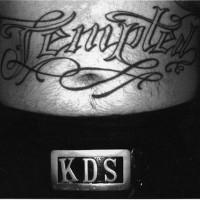 Stomach tattoo, tempted, curled styled  inscription