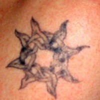 Knotted sun tracery tattoo