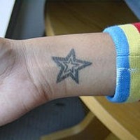 Black line star tattoo on wrist