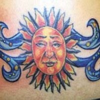 Lower back humanized sun tattoo