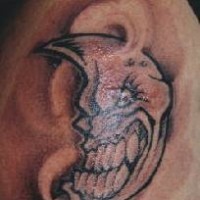Angry humanized moon tattoo