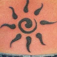 Black tribal sun symbol tattoo