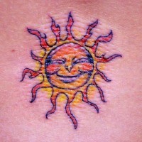 Tiny humanized sun tattoo
