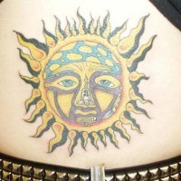 Colourful sun symbol tattoo on lower back
