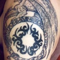 Dragon ouroboros with tribal tracery tattoo