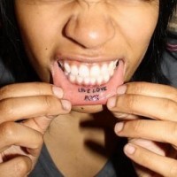 Tattooed on lip, live & love, little inscription