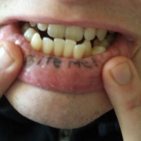 Tattooed on lip, bite me,  emphasizeds