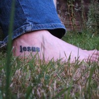 Jesus name tattoo on foot