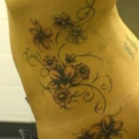 Side tattoo of vine with flowers