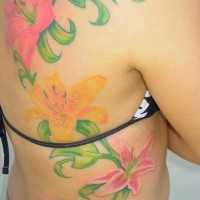 Tattoo on back and ribs, nice, pink, yellow, bright lilies