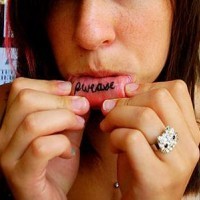 Tattoo on bottom lip, please, curled inscription