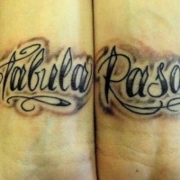Calligraphic tattoo with words Tabula Rasa on both wrists