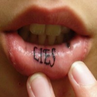 Text tattooed on lips, lies, black, thin word