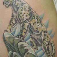 Leopard on rock tattoo