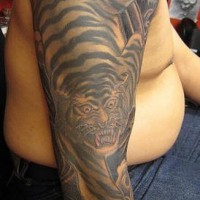 Black ink crawling tiger full sleeve tattoo
