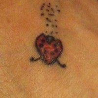 Tiny ladybug tattoo on foot