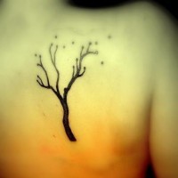 Scapula tattoo of lonely black tree