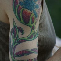 Arm tree tattoo with blue snowflake