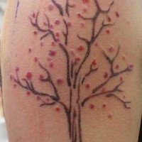 Tatouage artistique d'un arbre avec le floraison rouge