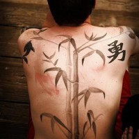 Whole back tattoo of bamboo and character