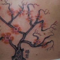 Tree tattoo with red flowers