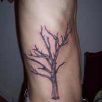 Side tattoo of lonely withered tree