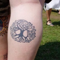 Small circle tree tattoo in black color