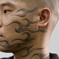Tribal flames face tattoo