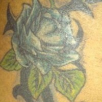 Tribal friendship symbol with flower tattoo