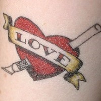 Heart symbol and scalpel tattoo