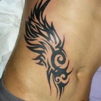 Winged tribal sign hip tattoo