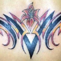 Tribal lower back tattoo with red flower