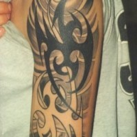 Black tribal phoenix tattoo on shoulder