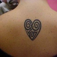 Black tribal heart tattoo on upper back