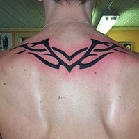 Black wings tribal tattoo on upper back