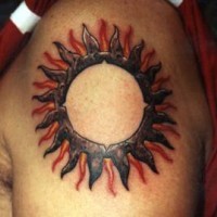 Big tribal sun tattoo on shoulder