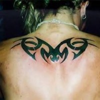 Upper back tattoo with black tribal sign