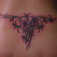 Tribal lateen tattoo with flowers on lower back