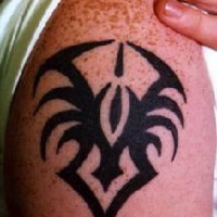 Shoulder tattoo with small tribal spider