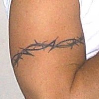 Tribal bracelet tattoo of barbed wire