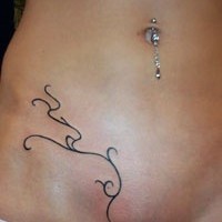 Lower belly tribal tattoo with thin twisted lines