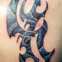 Dark colored tribal sign scapula tattoo