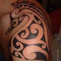 Tribal shoulder tattoo with seahorse