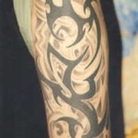 Gran tatuaje con los signos tribales en el brazo entero
