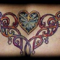 Colorful tribal tattoo with heart on lower back